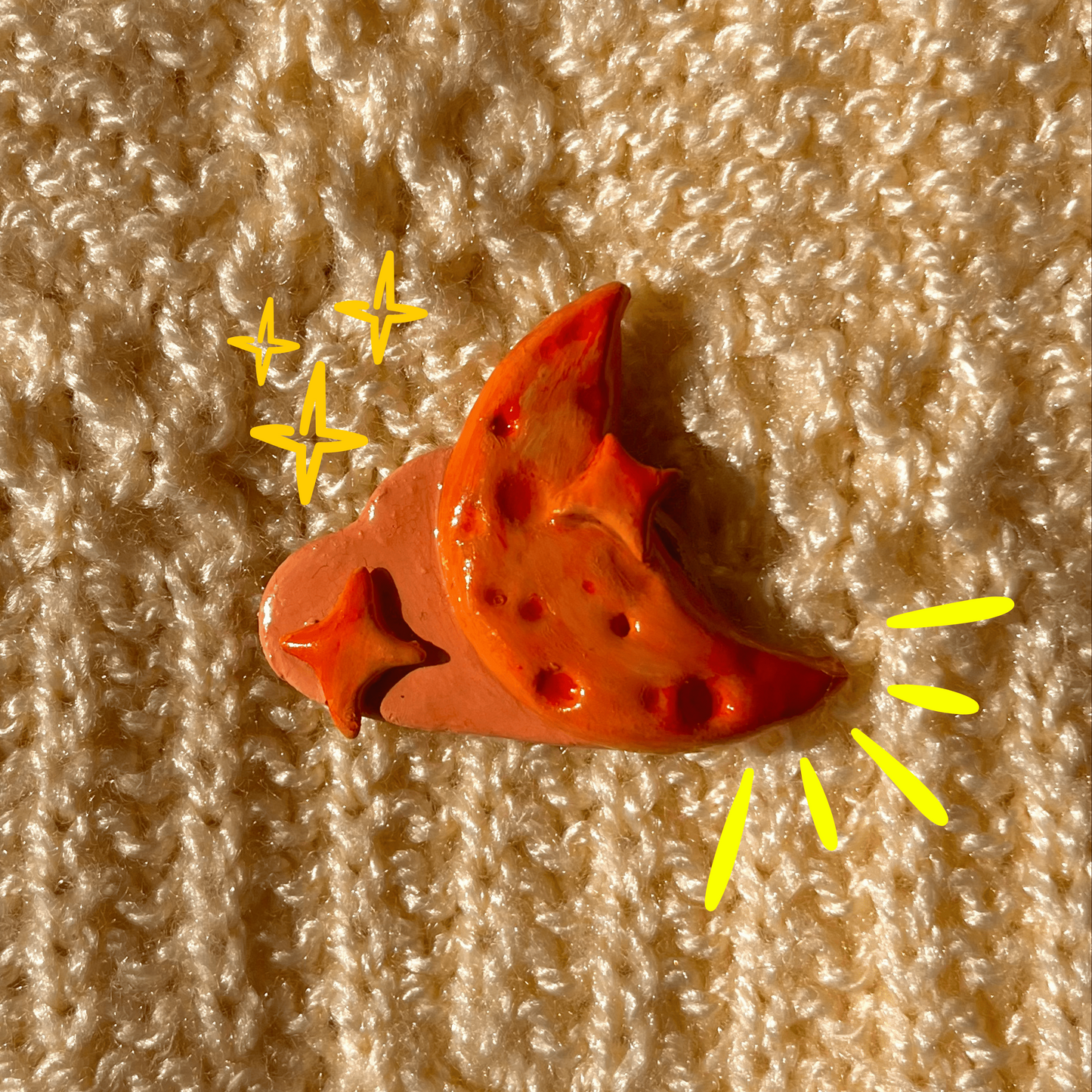 Red and orange object with yellow accents on a textured beige background
