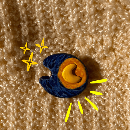 Colorful moon and star design on a textured beige surface