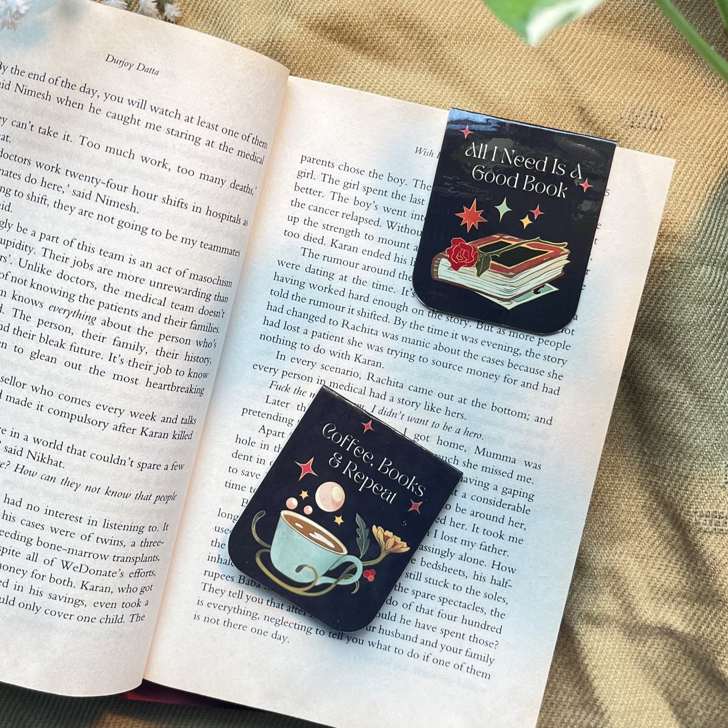Two decorative bookmarks on an open book with a natural background