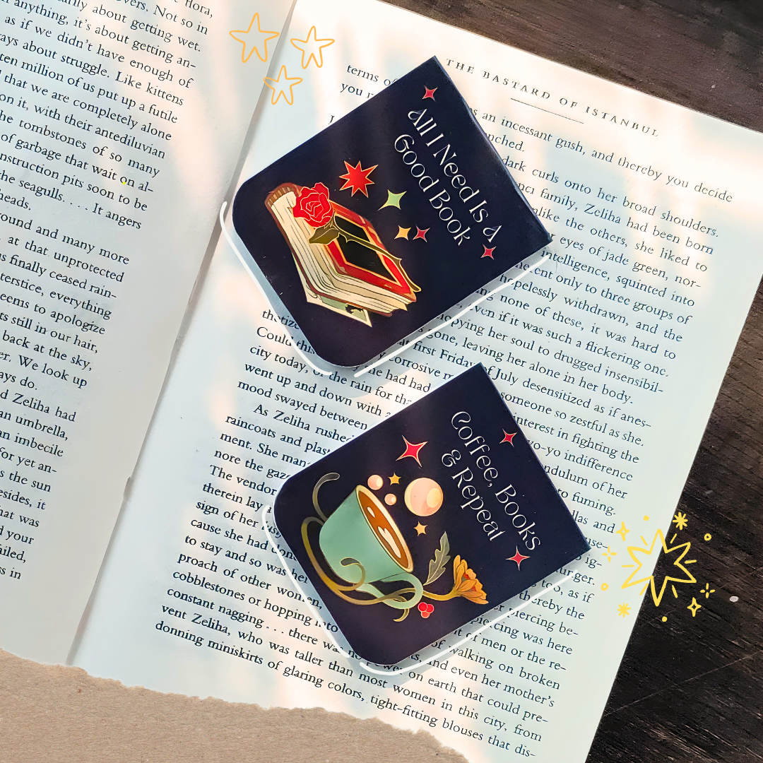 Two book-themed pins on an open book with visible text.