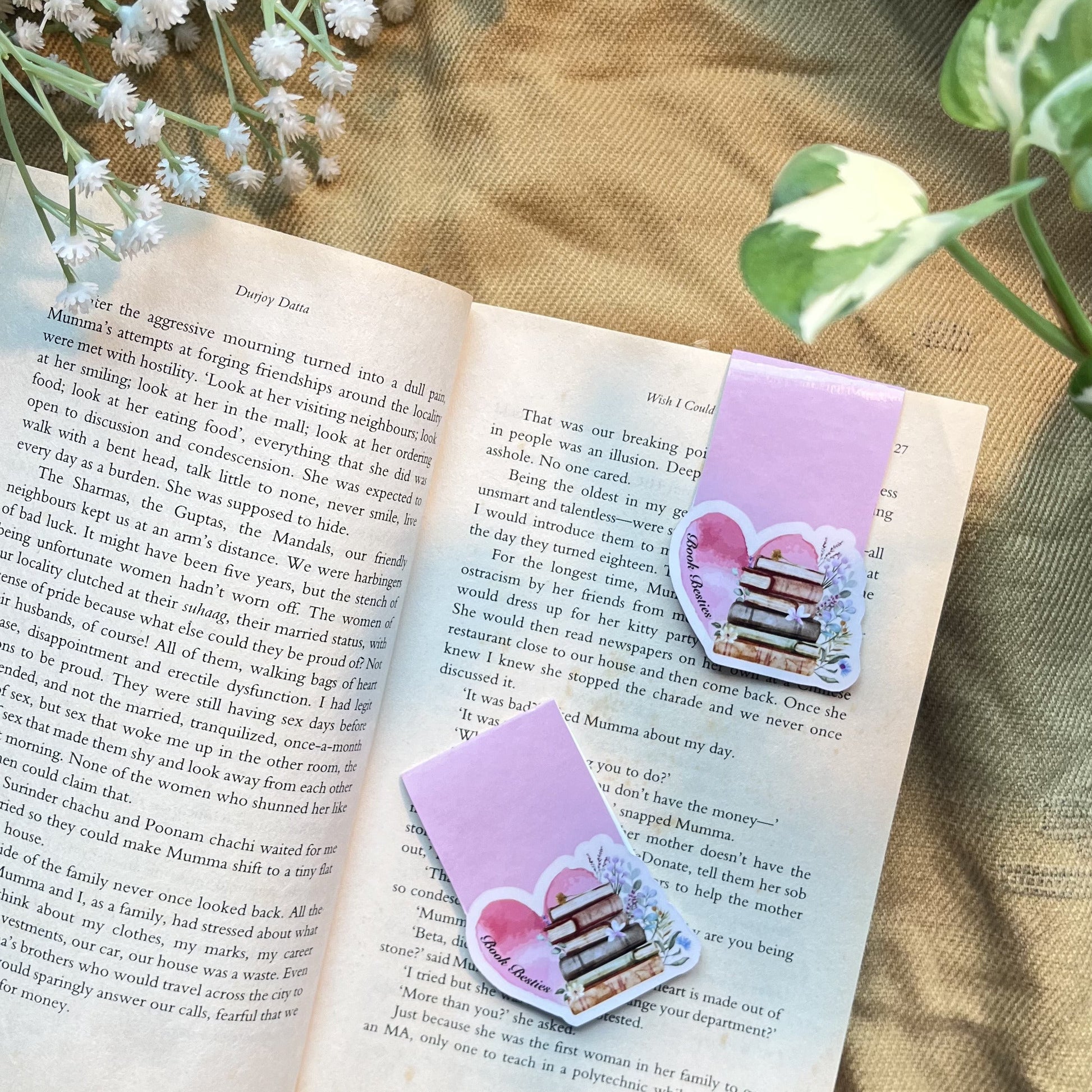 Heart-shaped bookmarks on an open book with a soft focus background